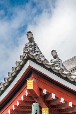 Asakusa, Tokyo, Japan - November 13, 2017: Onigawara (ogre goblin tile) roof ridge detail, crooked cross and Kazarikanagu (Metal ornaments) roof ridge  deatil at Senso-ji templeのeditorial素材