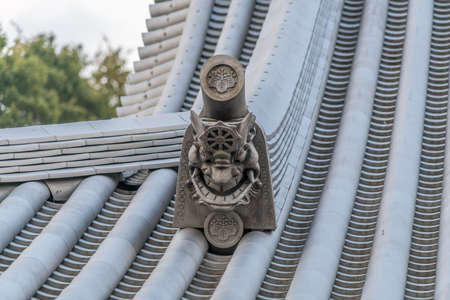 Zama city, Kanagawa Prefecture, Japan - November 15, 2017 : Beautiful Onigawara (Ogre tile) and toribusuma End tile at  Suijyousan Ryugein Temple.のeditorial素材