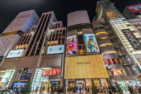 Ginza, Tokyo - December 2017 : Start of Christmas season in crowded Chuo dori street at Ginza luxurious shopping District by night.のeditorial素材