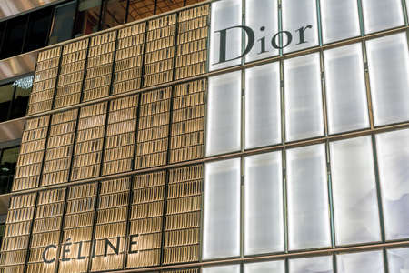 Ginza, Tokyo - December 2017 : Facade of Dior and Celine Shops in Chuo dori street at Ginza luxurious shopping District by night.のeditorial素材