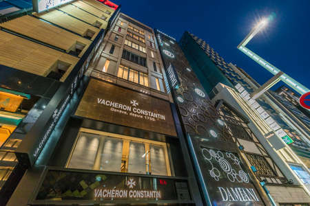 Ginza, Tokyo - December 2017 : Billboards and neon signs at Chuo dori street at Ginza luxurious shopping District by night.のeditorial素材