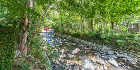 Izu, Shizuoka, Japan - August 10, 2018 : Katsura bridge over Kitamata River  Bamboo Forest Path known as "Narrow path", Shuzenji corridor of  beautiful Bamboo Forestのeditorial素材