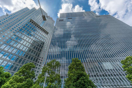 Tokyo - August 14, 2018 : Skyscrapers in  Nagatacho district: Capitol Hotel Tokyu or Tokyu Capitol Tower building and Sanno Park Tower. Sky reflections on the crystal facadeのeditorial素材