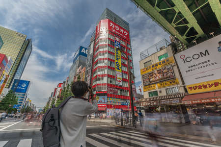Tokyo, Taito Ward, Akihabara - August 19, 2018 : Motion blurred people walking along shops and Colorful Billboard Advertisements at famous Akihabara Electric Townのeditorial素材