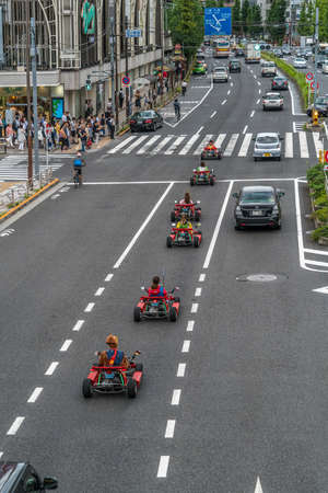 Tokyo, Shinagawa Ward - August 16, 2018 - Mario Karts go-karts whizzing through traffic in Shinagawa drivers wearing Mario Character costume now banned by Nintendoのeditorial素材