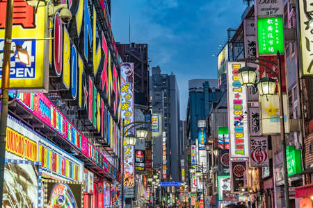 Shinjuku Ward, Tokyo - August 11, 2018 : Late afternoon scene in Kabukicho district. Crowded streets, shops and restaurants neon billboards.のeditorial素材