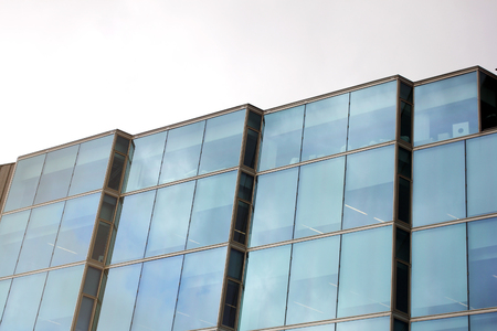 Isolated facade of office building and curtain walls of minimalism architectureの写真素材