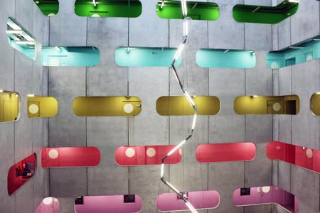 Industrial atrium, colorful corridors on different levels and zig zag lightの写真素材