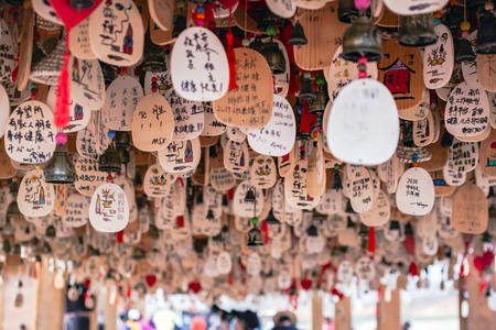 CHINA, ZHANGYE - SEPTEMBER 15, 2018. Hanging Prayers Are Written On Cards In Chinese Language. Wishes Pray To The God Are Suspended From Roof.