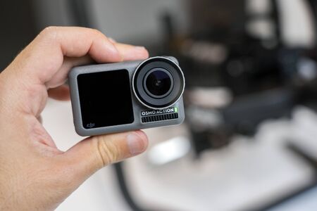 CHINA, SHANGHAI - MAY 18, 2019. A HAND IS HOLDING DJI OSMO ACTION. CLOSEUP VIEW.