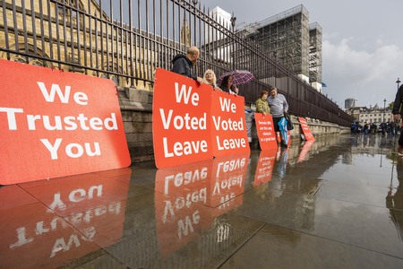 LONDON, UNITED KINGDOM - OCTOBER 1, 2019. Group of People are having a Rally by Palace of Westminster Supporting Brexit on the Rainy Day.のeditorial素材