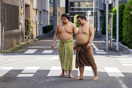 TOKYO, JAPAN - OCTOBER 7, 2018. Japanese Sumo Wrestlers are Having a Walk on a Street After Training.のeditorial素材