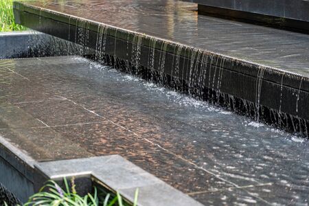 Small Cascade in the Open Air Courtyard. Water Feature as Part of Landscape Design.の写真素材