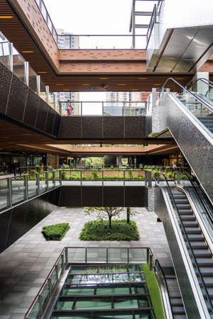 SHANGHAI, CHINA - NOVEMBER 10, 2018. Ruihong Tiandi Shopping Mall. External Courtyard of a Retail Complex with Escalators. Garden with Footbridge and Terraces. Green Sustainable Architecture.のeditorial素材