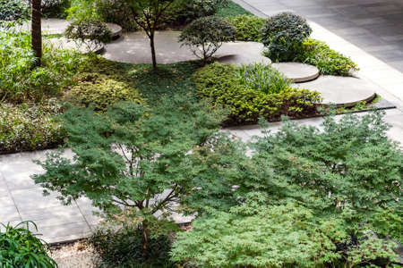 Round Concrete Steps in the Small Garden. Top View of Pathway Between Bushes and Trees. Landscape Design of Sustainable Green Architecture. Stepping Stones at Greenery.のeditorial素材