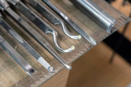 Set of Carving Metal Tools for Woodwork at Workshop. Fretsaw Stainless Steel Hardware Kit on Table.の写真素材