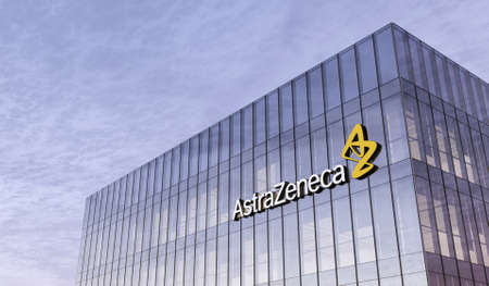 Cambridge, United Kingdom. February 16, 2021. Editorial Use Only, 3D CGI. Pharmaceutical Company Astrazeneca Signage Logo on Top of Glass Building. Workplace in High-rise Office Headquarter at Night Time.のeditorial素材