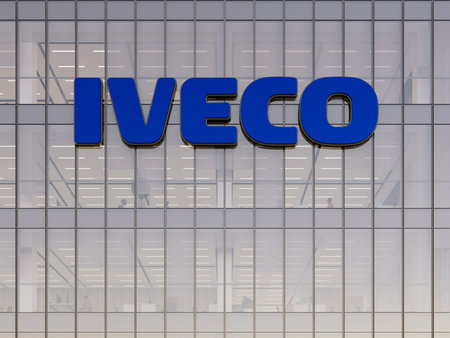 Turin, Italy. May 2, 2023. Editorial Use Only, 3D CGI. Iveco Signage Logo on Top of Glass Building. Workplace of Vehicle Manufacturer Company Office Headquarters.のeditorial素材
