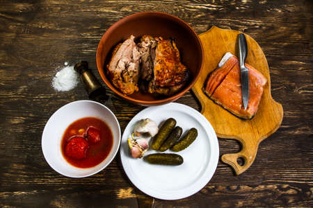Tasty turkey meat and salt salmon fillet looks good with honest, tomatoes, cucumbers and freshly baked breadの写真素材