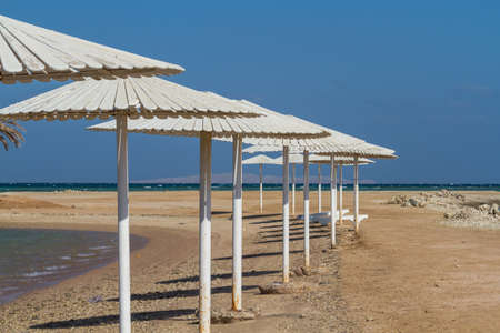 Umbrellas, beach chairs, tents on the beach in the sun when the dawn.の写真素材