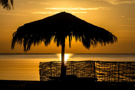 Umbrellas, beach chairs, tents on the beach in the sun when the dawn.の写真素材