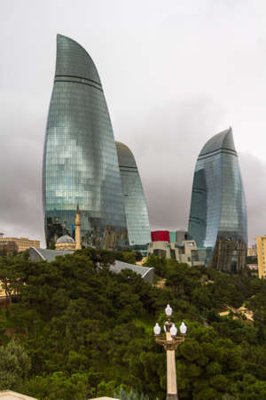 Landscapes of autumn Baku, Azerbaijan. Old and new - a modern skyscraper and an ancient mosque.のeditorial素材