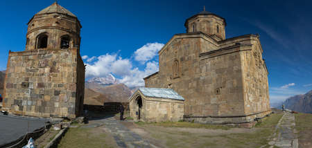 The Trinity Church in Gergeti is located at an altitude of 2,170 m at the foot of Kazbek along the Georgian Military Road in the Georgian village of Gergeti on the right bank of the river Cheheri, directly above the village of Stepantsminda.のeditorial素材