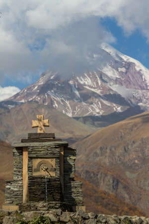 The Trinity Church in Gergeti is located at an altitude of 2,170 m at the foot of Kazbek along the Georgian Military Road in the Georgian village of Gergeti on the right bank of the river Cheheri, directly above the village of Stepantsminda.の写真素材