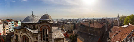 Panorama of the roofs of the old district of Istanbul with a view of the Yellow Sea and the ships standing in the roadstead. Ancient Christian church and mosques aroundのeditorial素材
