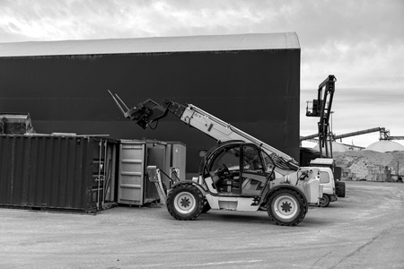 The field at the hangar standing yellow loader.の写真素材