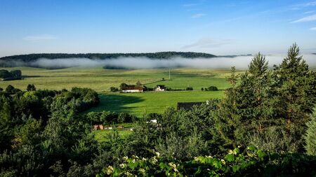 Landscape with morning fog, plains and mountains.の写真素材