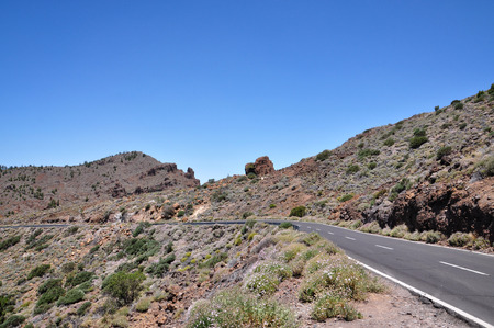 Mountain road to volcano Teide among rocky mountains on Tenerife island.の写真素材