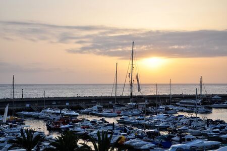 TENERIFE, SPAIN - JULY 1, 2011: Marina by the ocean at sunset.