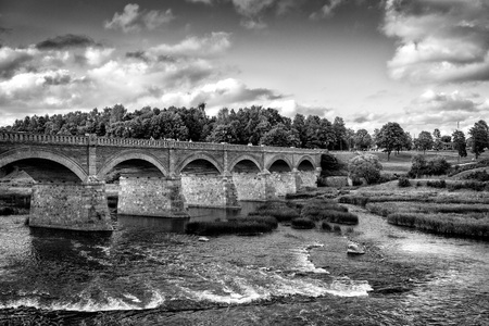 Old bridge with arches over the river.のeditorial素材