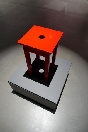 On the illuminated podium standing in a red chair.の写真素材