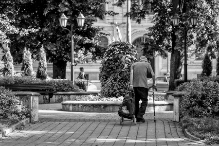 RIGA, LATVIA, AUGUST 14, 2015: Unknown old man pulled the bag on wheels.のeditorial素材