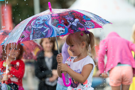 RIGA, LATVIA - AUGUST 17, 2014: People on the streets of Riga City Festival. Children are happy with water attractions.のeditorial素材