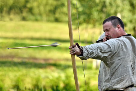 TERVETE, LATVIA - AUGUST 13, 2011: Historical Zemgalu days. Unknown archer demonstrate his skill.のeditorial素材