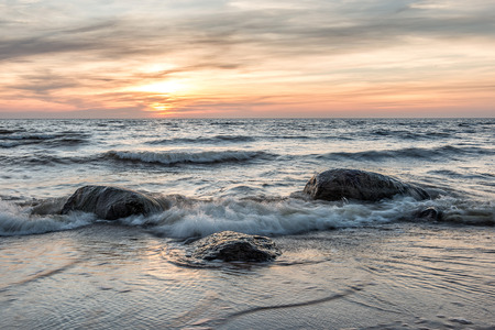 Sea landscape. Sea and stones at sunset.の写真素材