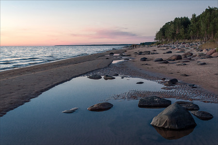 Sea landscape. Rocky beach at sunset.の写真素材