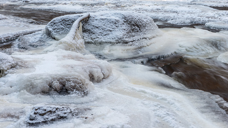 Winter landscape. Frozen rocky river. Ice and snow.の写真素材