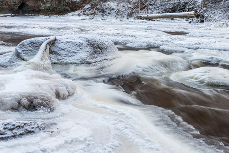 Winter landscape. Frozen rocky river. Ice and snow.の写真素材