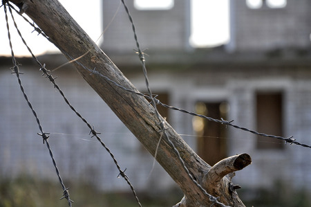 A protection zone of barbed wire at the old buildings.の写真素材
