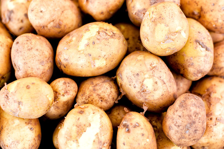 A stack of potatoes for sale in marketの写真素材