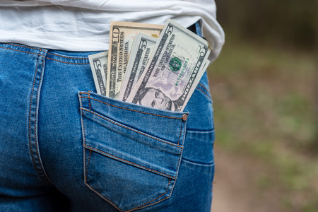 Money in rear jeans pocketの写真素材