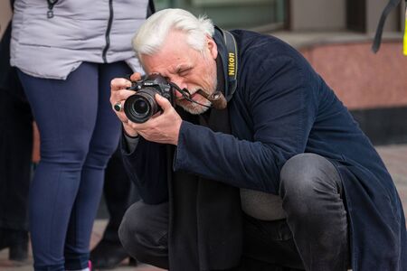 RIGA, LATVIA - APRIL 28, 2018: 2018 Moto Season Opening Event. Motorcyclists gather for a parade trip. Photographer photographs motorcycles and parade participants.のeditorial素材