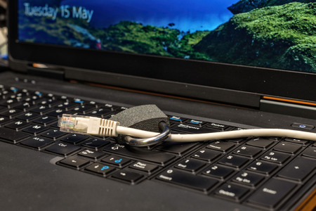 lock and network cable as symbol for Privacy and General Data Protection Regulation on a notebook computerの写真素材