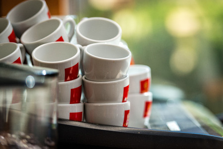 Stacks of coffee cups on coffee machineの写真素材