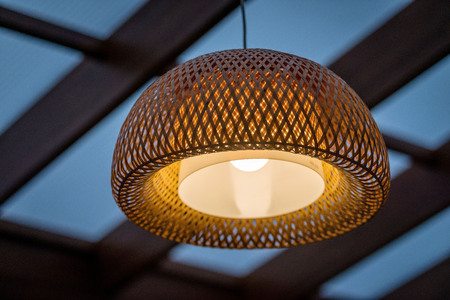 Interior of the outdoor terrace with a wicker wood ceiling lamp.の写真素材