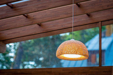 Interior of the outdoor terrace with a wicker wood ceiling lamp.の写真素材